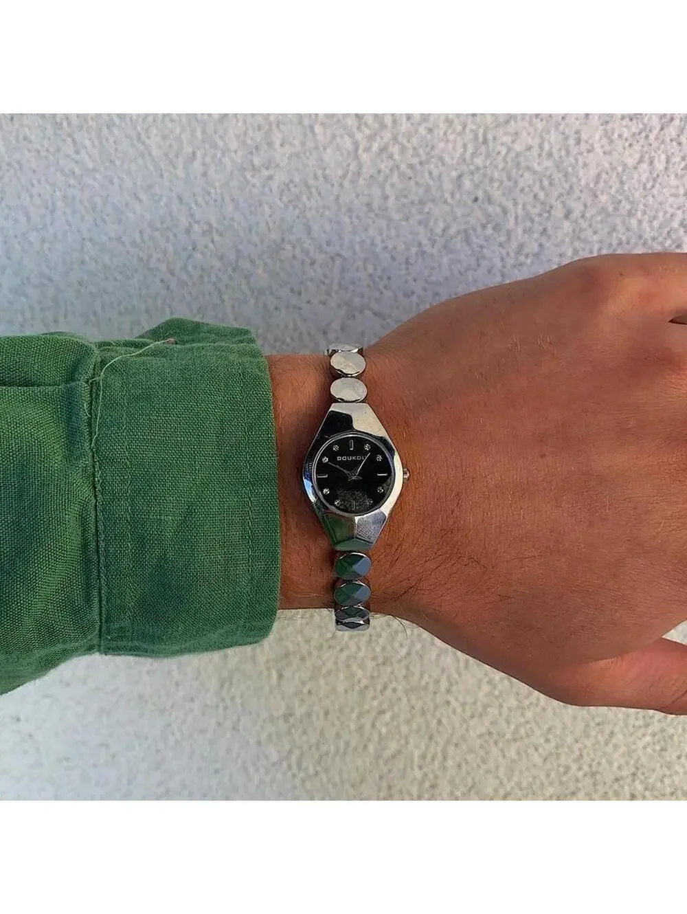 Black and silver watch with a unique design with rhinestones